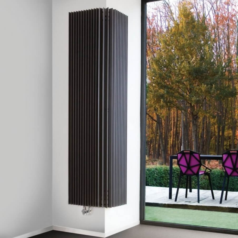 Modern Column Radiator in a home setting in a anglular corner setting