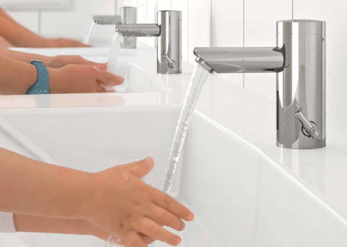 Kids washing hands from sensor taps